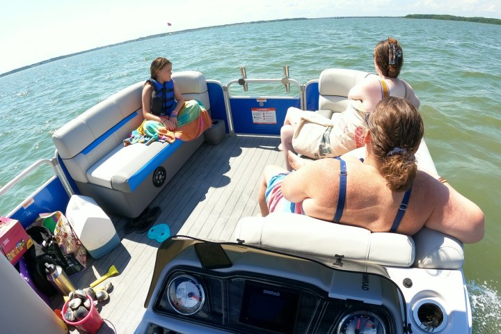 a person sitting in a boat on a body of water