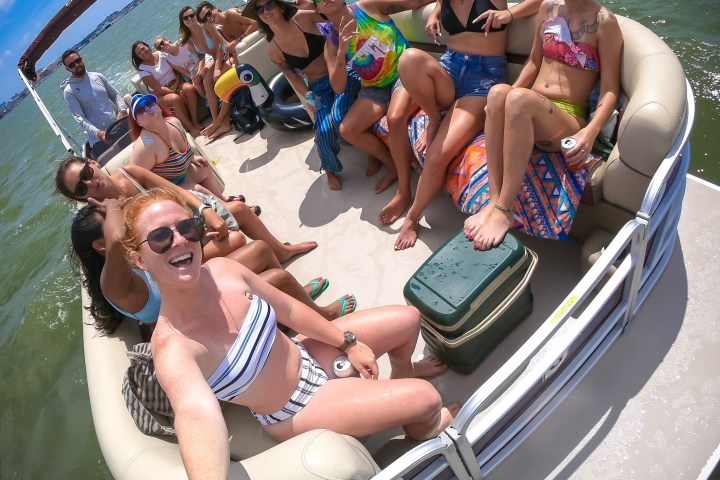 a group of people riding on the back of a boat