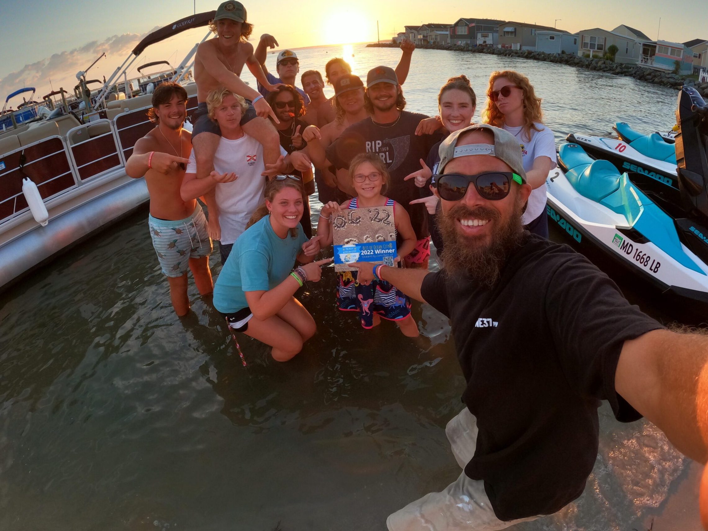 a group of people standing next to a body of water